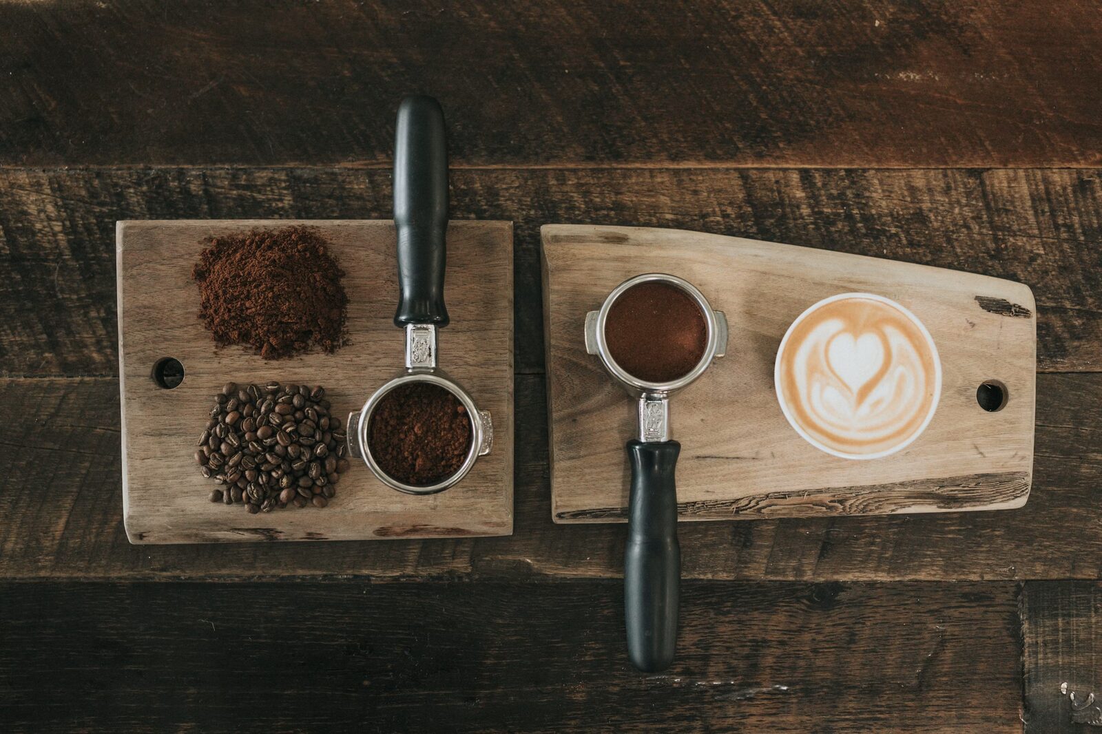 Coffee beans, portafilter and latte art on a wooden board at GW Coffee House